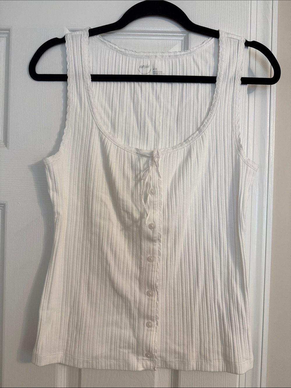 Classic White Ribbed Button-Front Tank Top. There are shadows on the picture.